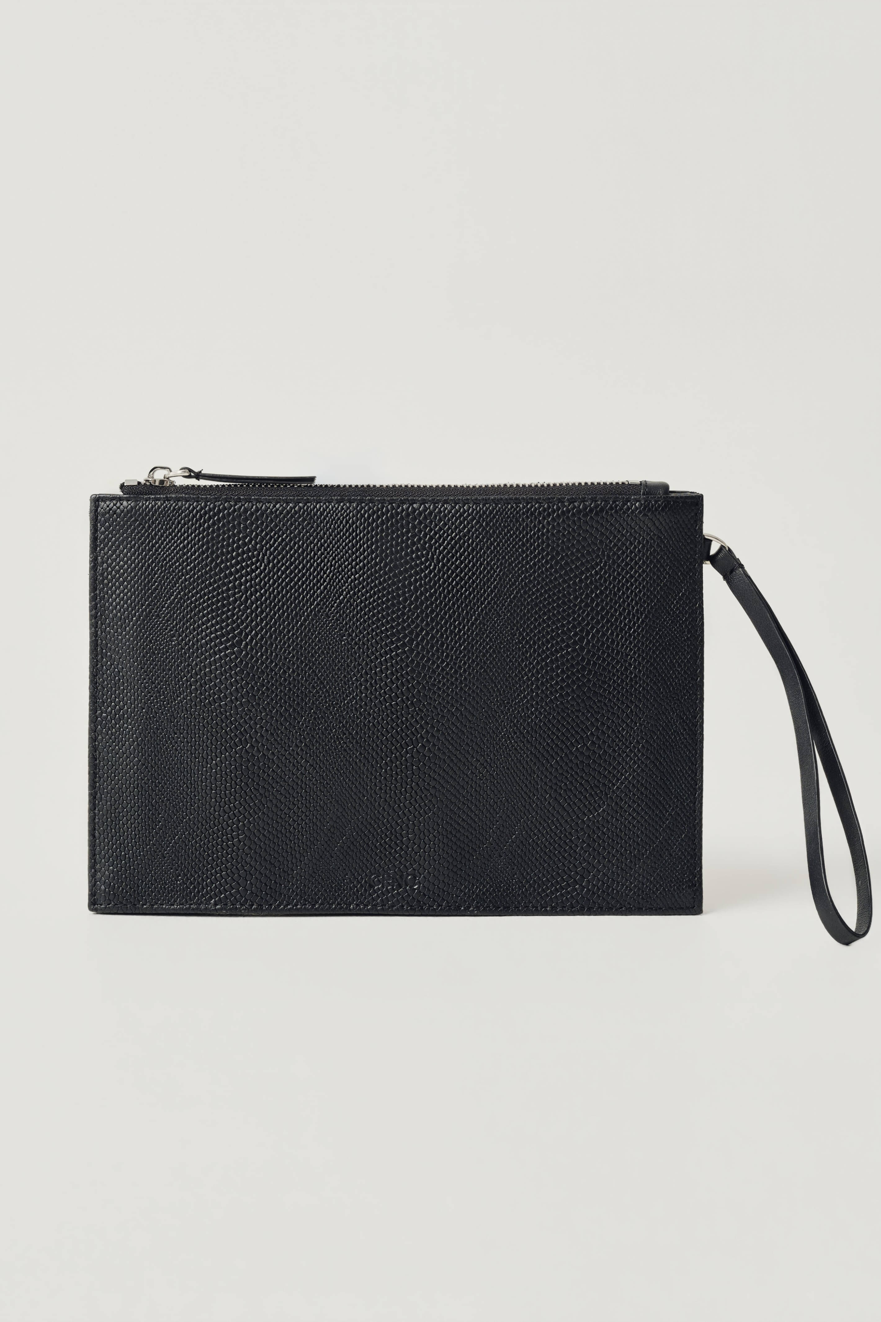 A black textured leather wristlet pouch with a top zipper and an attached wrist strap, shown against a plain light gray background.