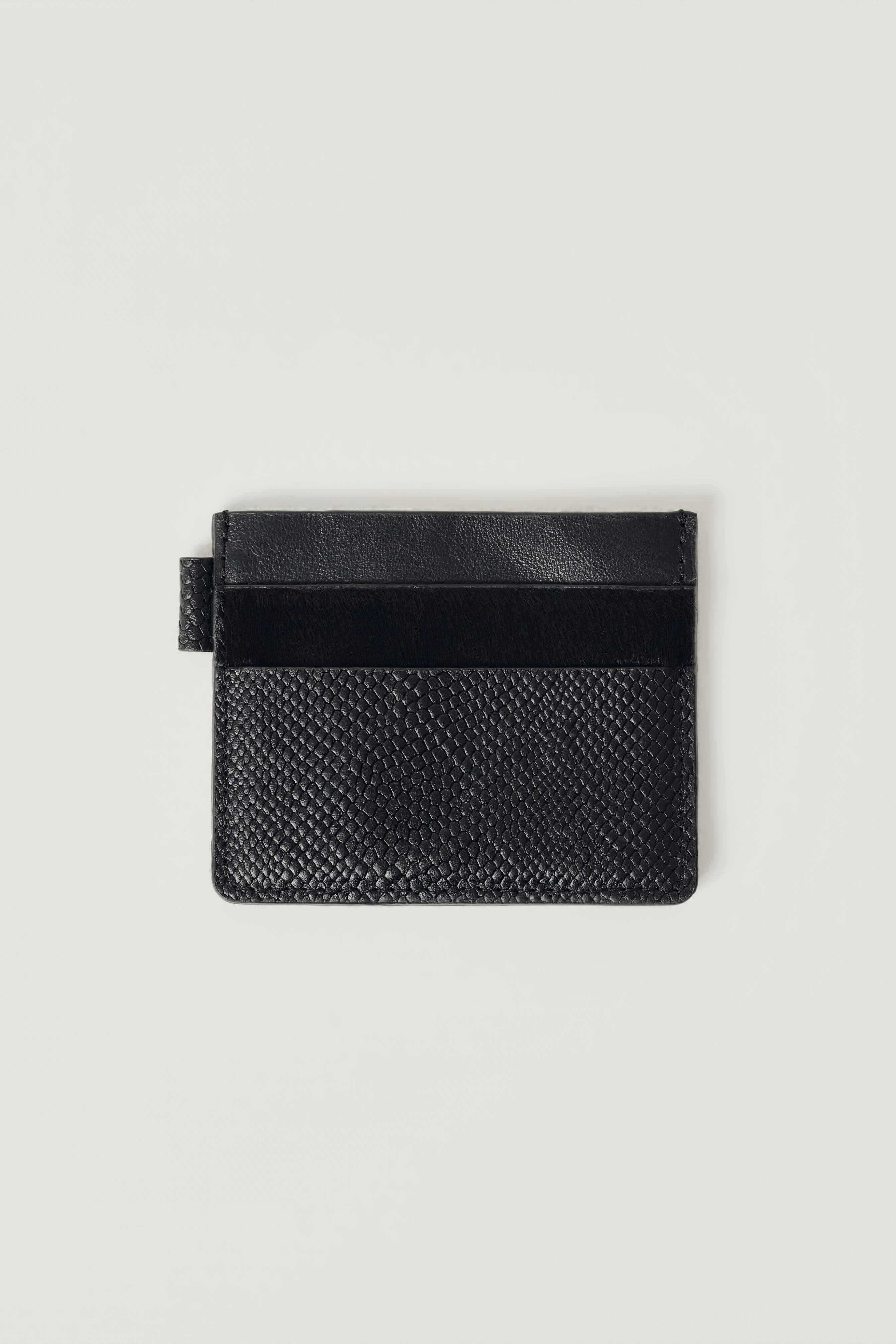 A black leather card holder with a textured python-patterned lower half and a smooth black top band, shown flat on a light gray background.